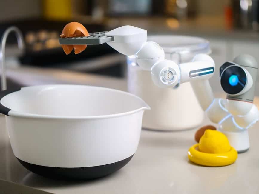 A robotic helper cracks an egg into a bowl in a contemporary kitchen setting, showcasing automation in cooking.