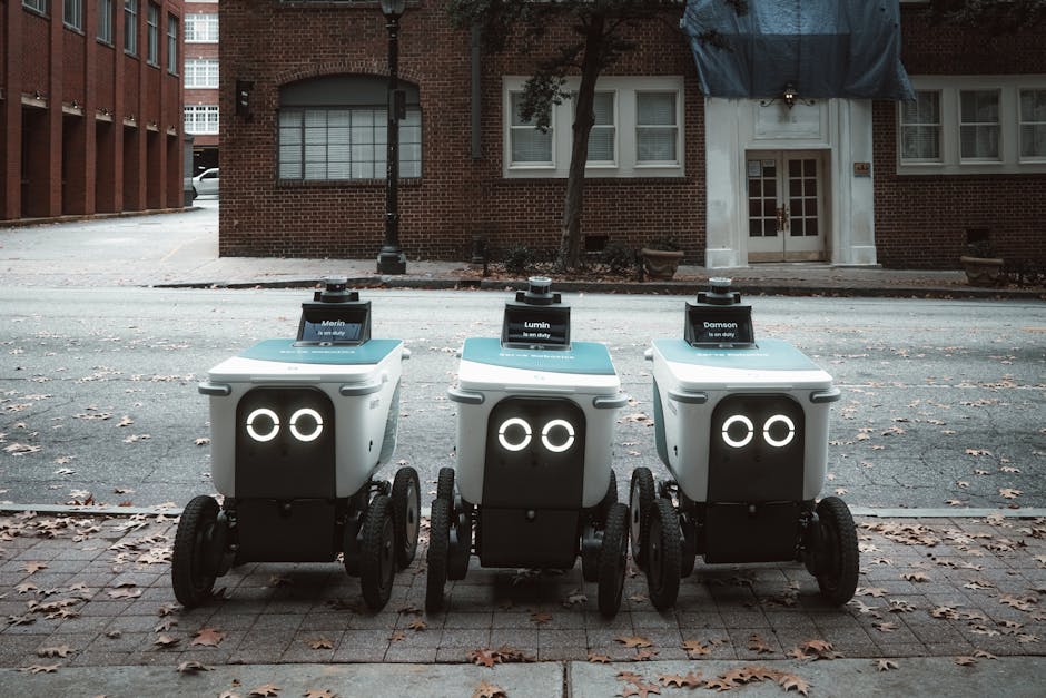 Autonomous delivery robots positioned on an urban street, showcasing technology in modern logistics.