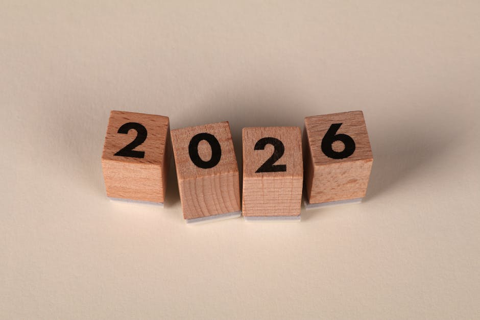 Wooden cubes forming the year 2026 on a neutral background.
