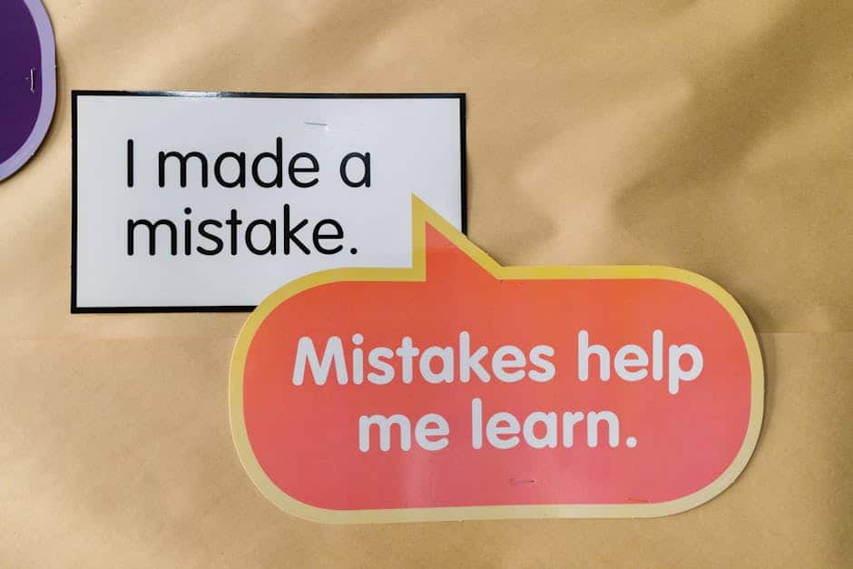 Bright square and speech bubble sign with motivational quotes about mistakes and learning.