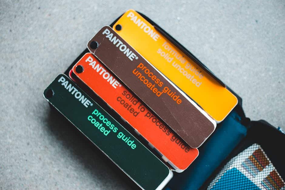 Top view of Pantone color guides showcasing vibrant shades for creative design projects.