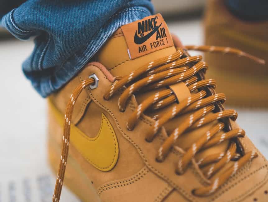 Detailed shot of brown Nike Air Force 1 sneakers with laced design and subtle branding.