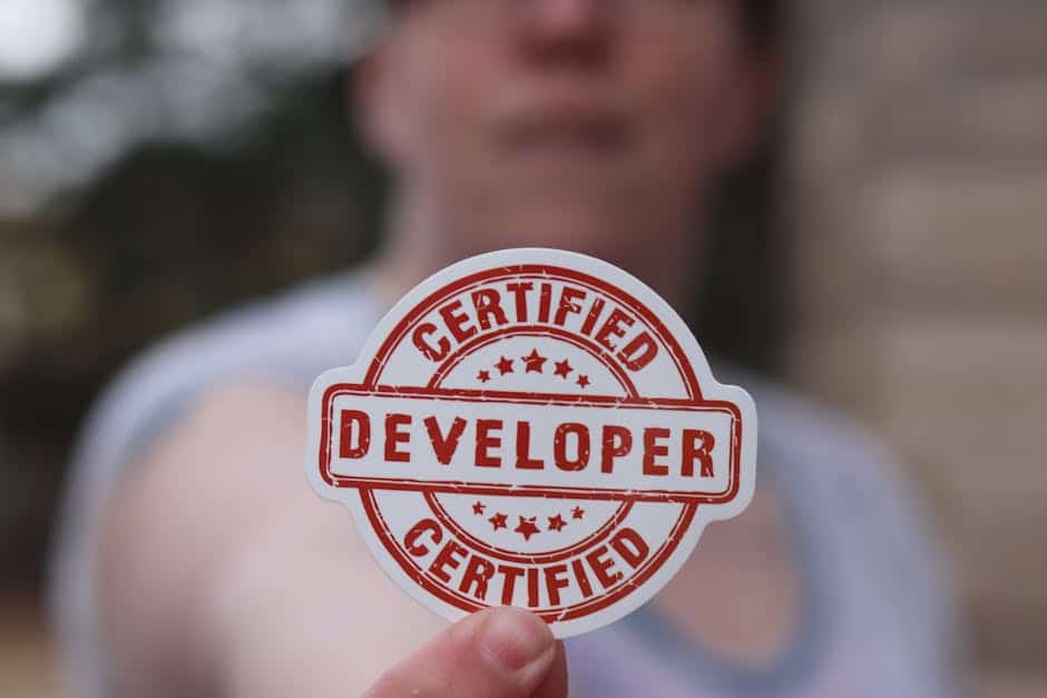 Close-up of a certified developer badge being held outdoors.