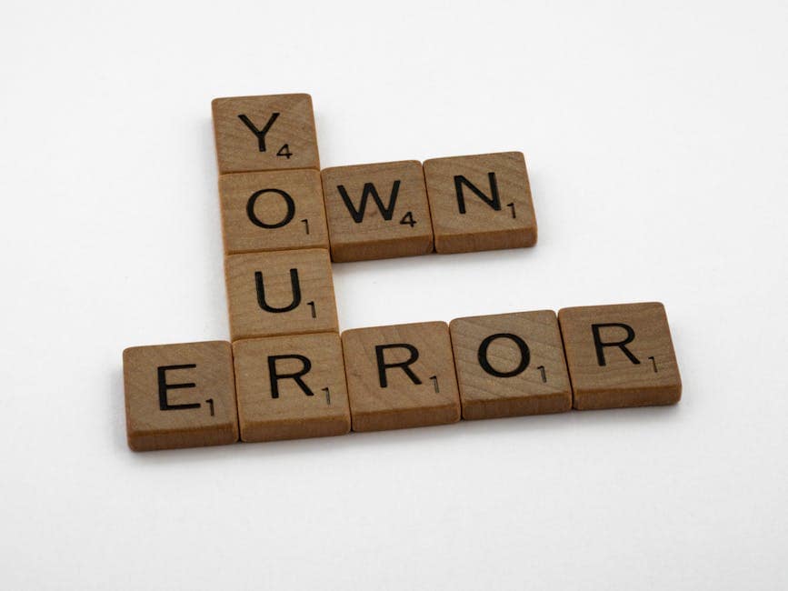 Scrabble tiles spelling 'Own Your Error' on a white background.