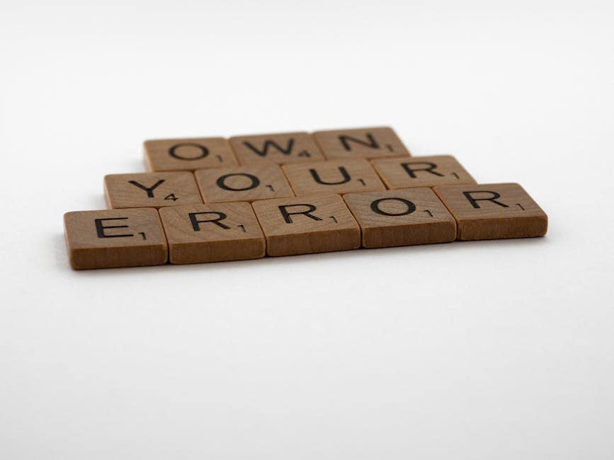 A motivational phrase assembled with Scrabble tiles on a white background.
