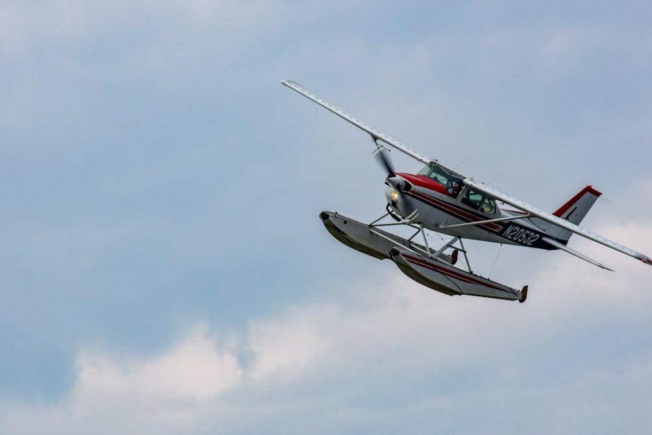 A floatplane gracefully flying in the clear blue sky over Grand Rapids, MN.