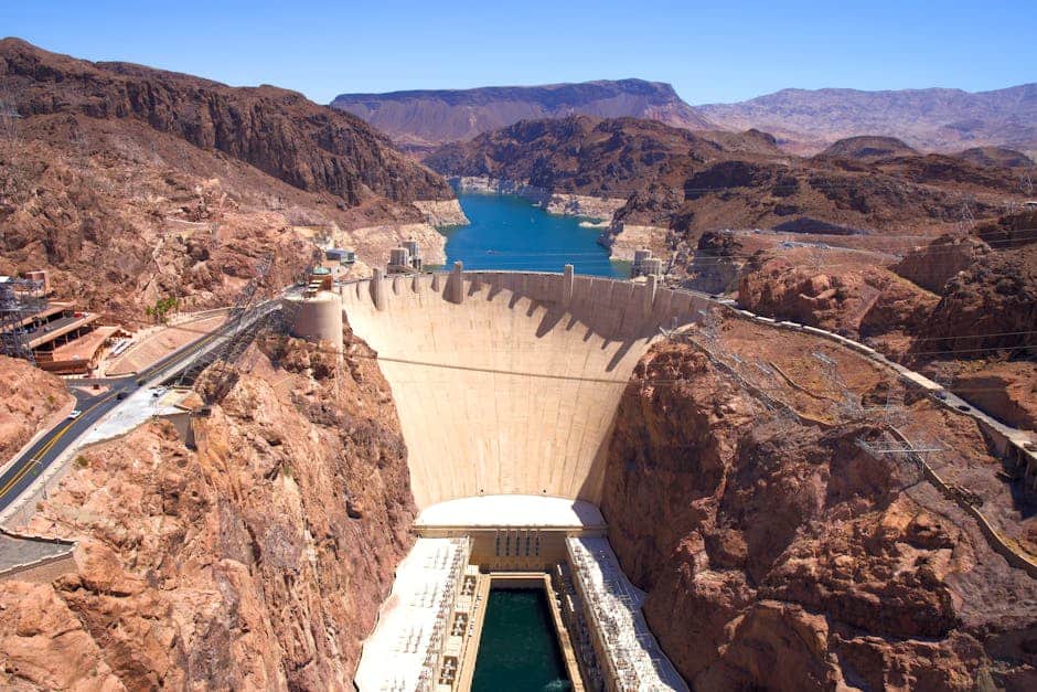 A breathtaking aerial shot of the Hoover Dam under a clear blue sky.