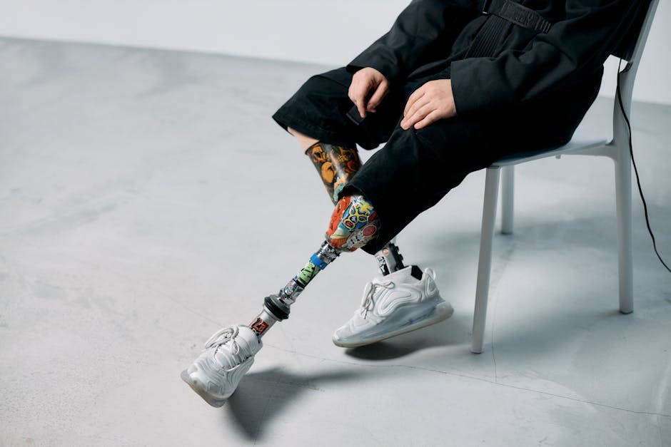 Colorful prosthetic legs in a minimalist studio, showcasing innovation and technology.
