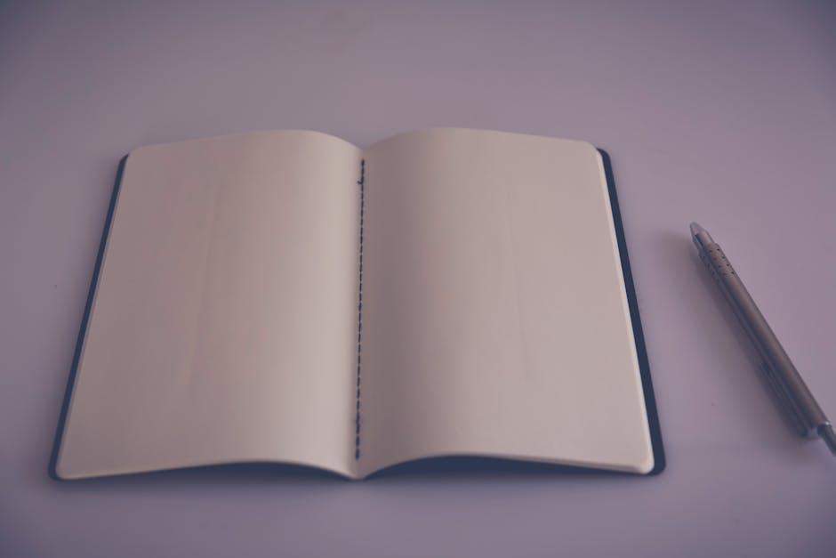 A minimalist photo of an open notebook with a pen on a blank page, ideal for creative projects.