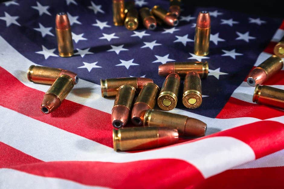 Close-up of ammunition on the American flag, signifying defense and patriotism.